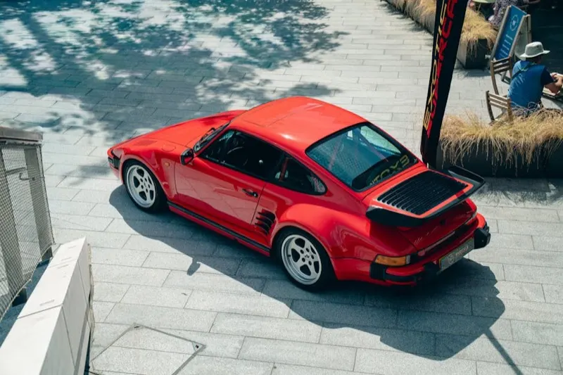 Porsche 911 Turbo (930) in Guards Red, rear three-quarter with whale-tail spoiler